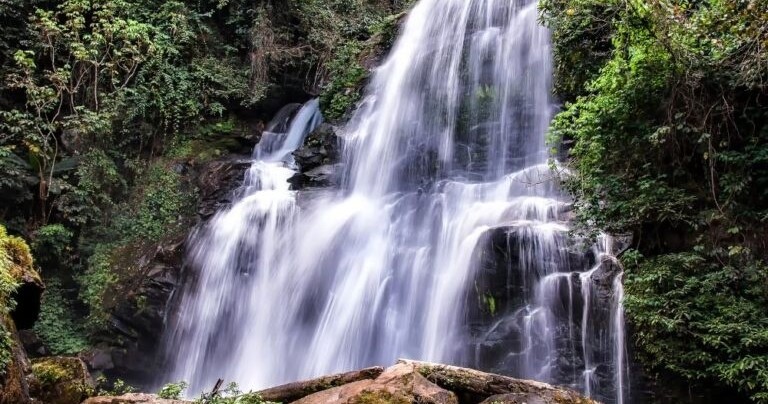 Scenic jungle waterfall cascading through tropical forest in Chiang Mai