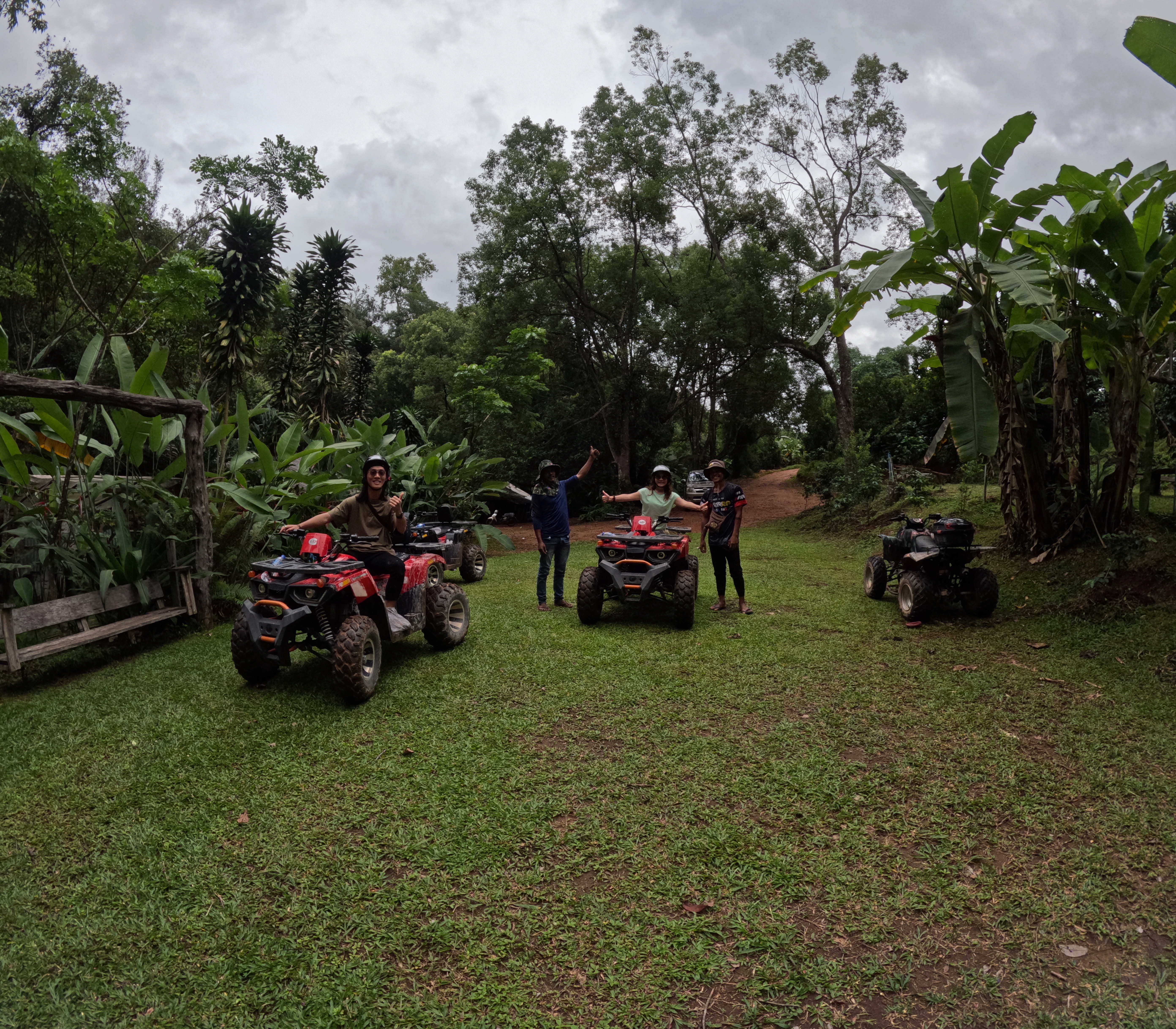 Guests riding ATVs through a tropical jungle trail in Chiang Mai