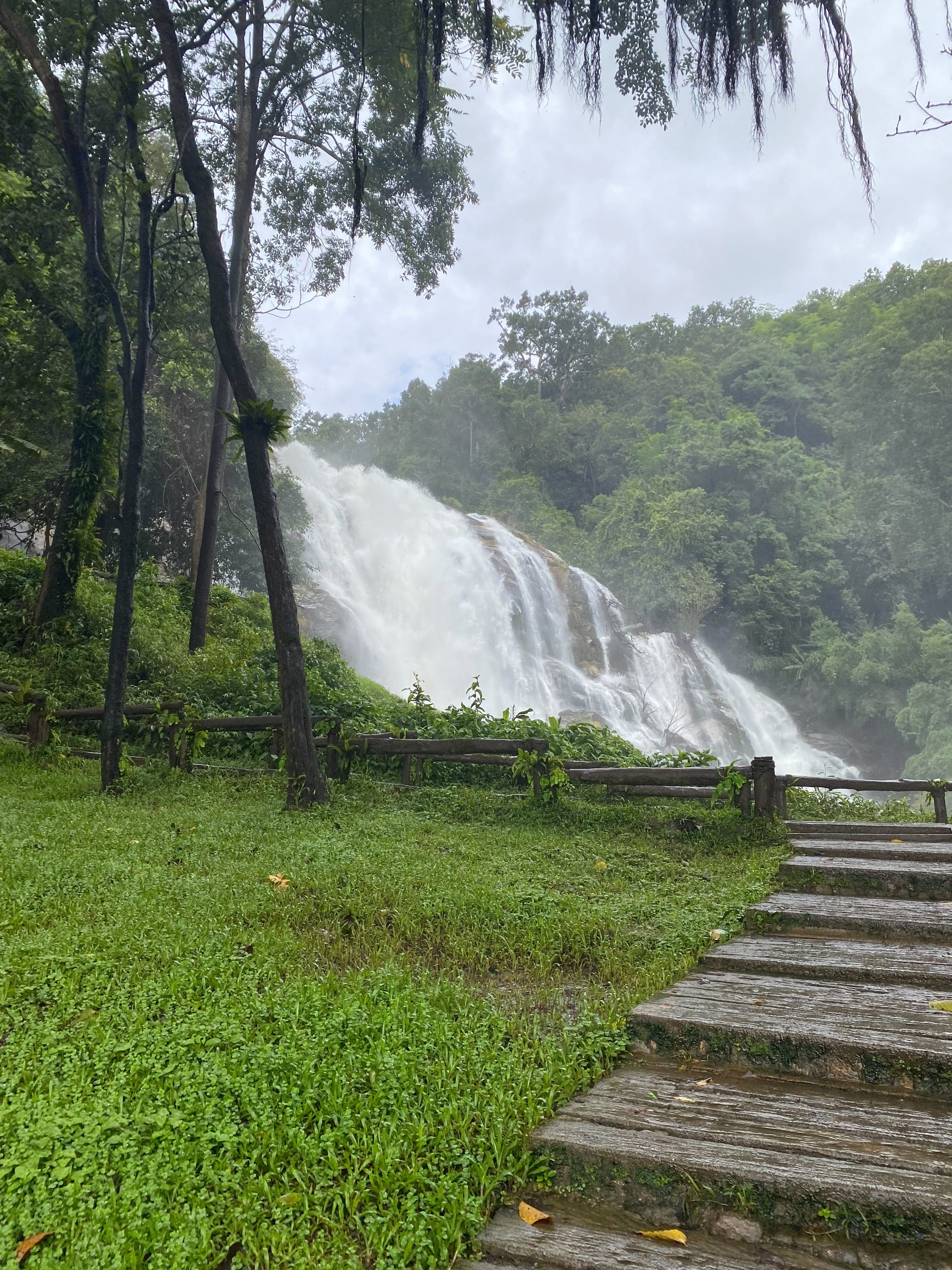 Large waterfall surrounded by lush rainforest in Chiang Mai